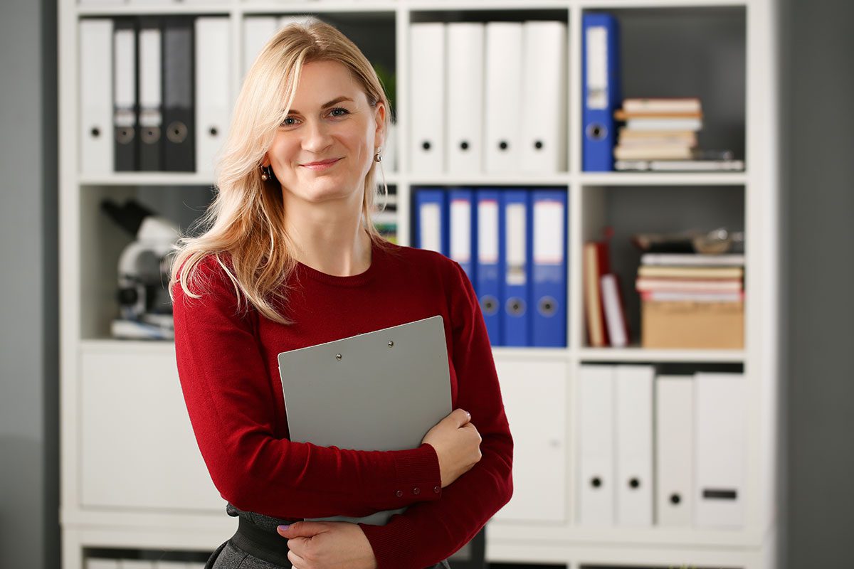 Lady holding clipboard in office
